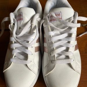 Women Adidas shoes with rose gold stripes